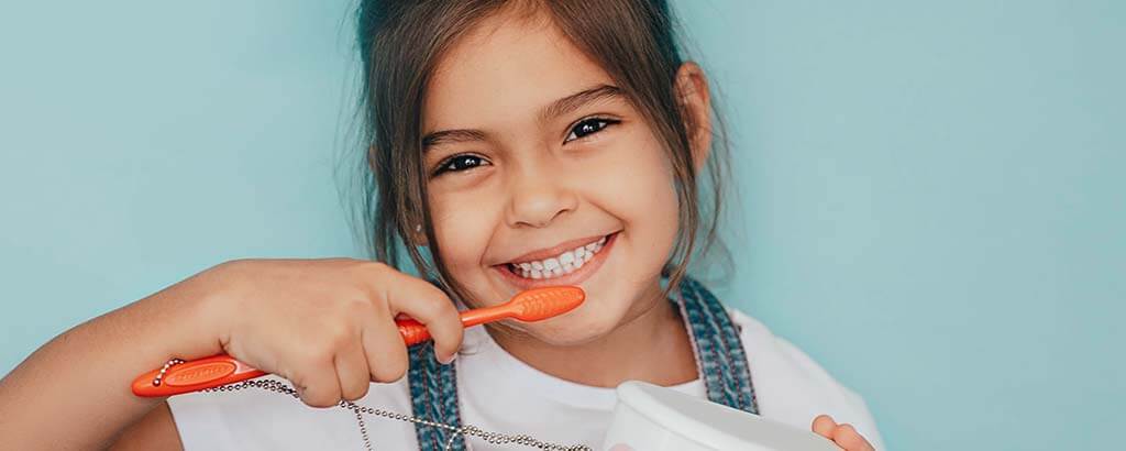 a child demonstrates tooth brushing after receiving pediatric dentistry