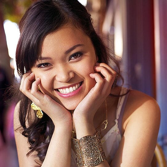 a young woman smiles as she remembers that brightening your smile is easy